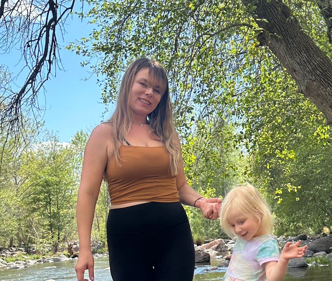 Blair Adrian Harring with child by stream